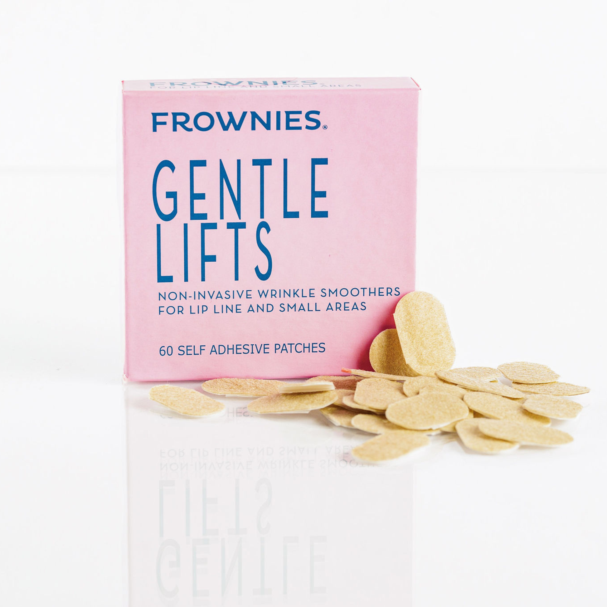 Frownies Gentle Lifts – Rosa förpackning med 60 självhäftande ansiktsplåster för läpplinje och små områden, utspridda framför förpackningen.