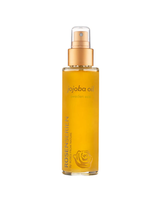 Rosenserien Jojoba Oil i guldfärgad flaska med spraypump.
